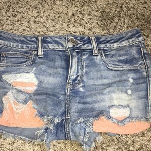 Ripped jean shorts with pink sleeves